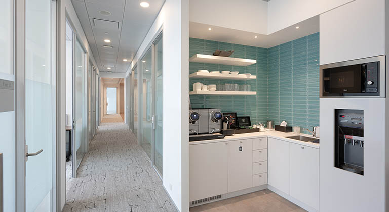 Pantry area and nearby meeting rooms at TEC Centres in Hong Kong, where Members can enjoy complimentary refreshments