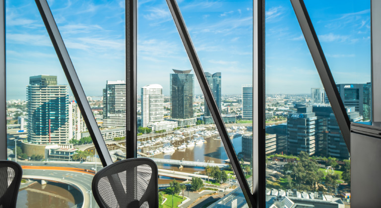 A city view from an office window, highlighting urban architecture and a bright sky, reflecting a lively metropolitan atmosphere from our Centre in Australia