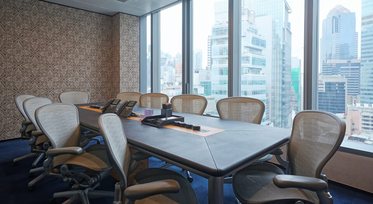 A sophisticated meeting room inside The Executive Centre, equipped with a large conference table, ergonomic chairs, advanced audiovisual technology, and a well-lit, professional setting designed for productive discussions and presentations