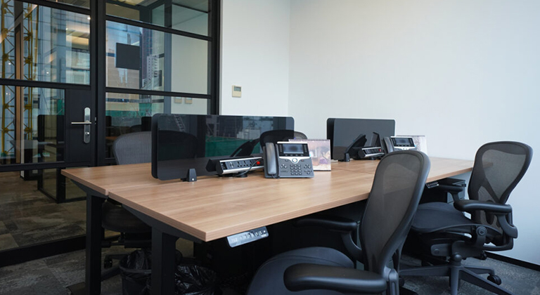 A sleek private office inside The Executive Centre, featuring a spacious desk, ergonomic chair, modern decor, large windows with natural light, and a quiet, professional atmosphere ideal for focused work