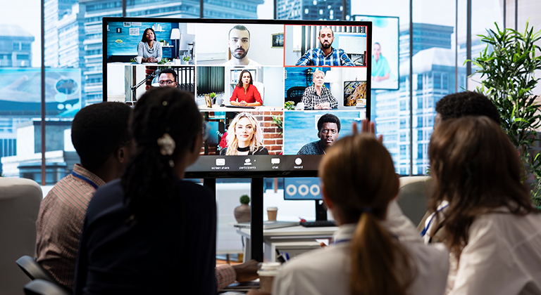Executive presenting in hybrid meeting room