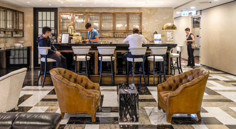 ​​Elegant coffee bar with sleek design, artisan beverages, and comfortable lounge seating at 3 Garden Road in Hong Kong