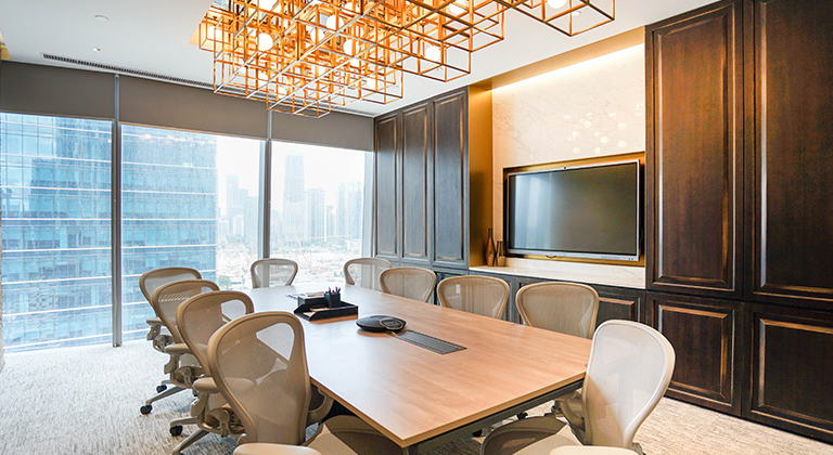 A 10-person meeting room, equipped with a large central table and several chairs for participants