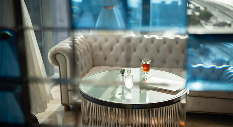 A cozy lounge area in KAFD 3.09 Centre of TEC in Riyadh, featuring plush armchairs, stylish sofas, modern coffee tables, warm lighting, and elegant decor, creating a relaxed and inviting atmosphere for informal meetings or relaxation